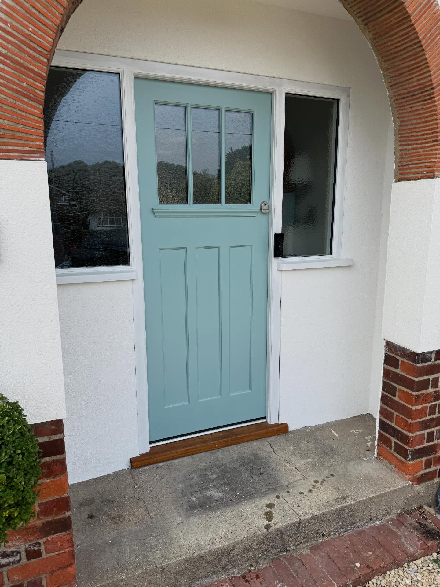 Refurbished porch with new render and painted door
