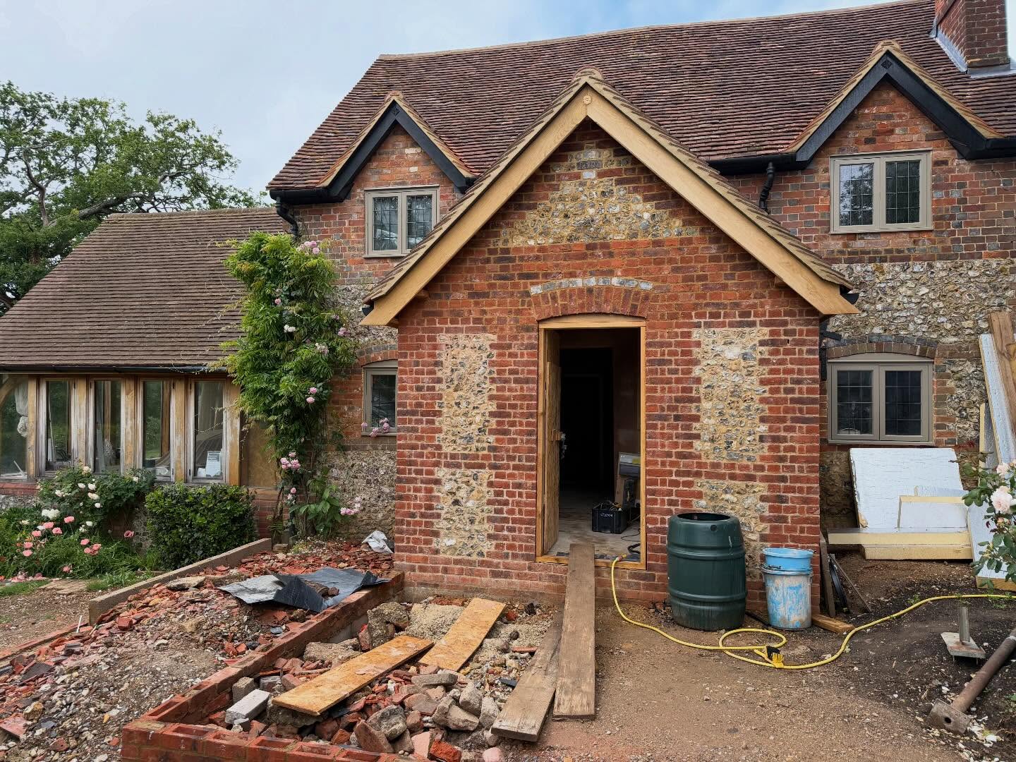 Brick and flint cottage extension by Clifford Beard Plastering